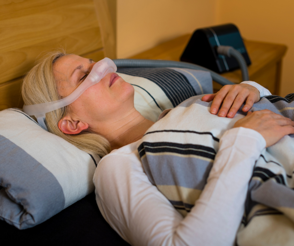 Eine Frau schläft mit einer CPAP-Maske